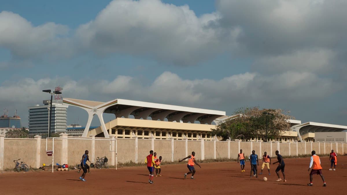 Footballers practising near the National Stadium in Accra; a licensed editorial photograph used for African football context, not a photograph of Ilenikhena or Usor.