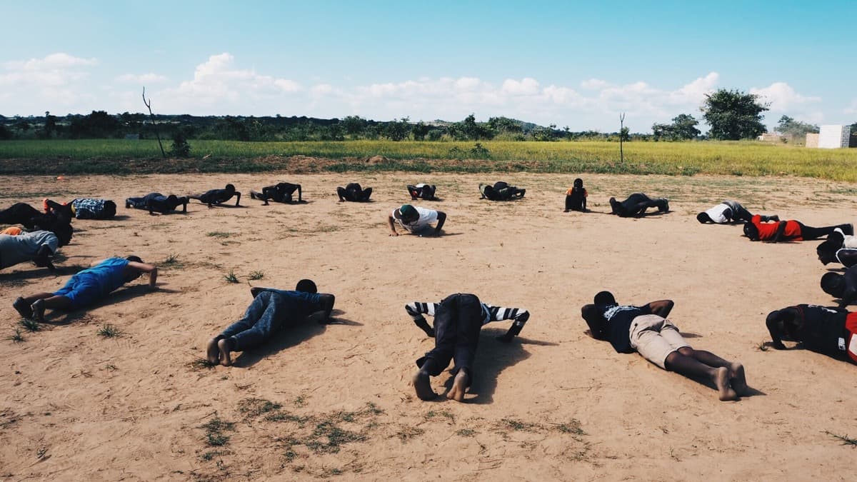 Footballers taking part in training exercises on an outdoor pitch; a licensed editorial photograph used for an AFCON qualifying explainer.
