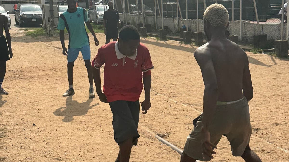 A grassroots football match near Nigeria's National Stadium; a licensed editorial photograph used as context, not a photograph of Guinea-Bissau v Nigeria.