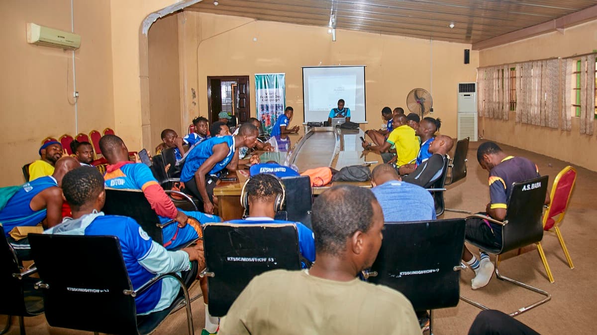 Football players and coaches at a World Football Day session in Nigeria; a licensed editorial context photograph, not an image from the match in Bissau.